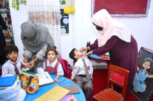 Lady Health workers administering polio drops to child student to kicks off nationawide Polio Eradication Programme 2024 at local private