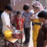 A young boy selling traditional Chaat on the street side to earn his livelihood