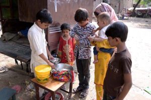 A young boy selling traditional Chaat on the street side to earn his livelihood