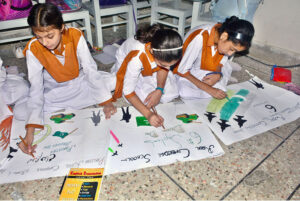Students participating in painting competition on the occasion of Pakistan Defense Day in a local school at Latifabad