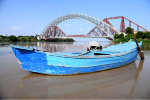 A view of boat parked in front of Lansdowne Bridge and Ayub Bridge at Left Bank of Indus River near Rohri