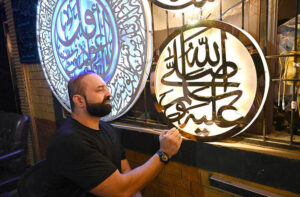 An artist creates beautiful calligraphy in metal art (Arashi Kitba) in preparation for Eid Milad-un-Nabi (PBUH) celebrations in the provincial capital.
