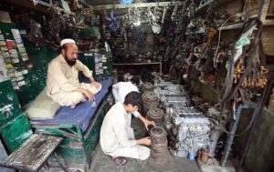 A vendor waits patiently for customers, selling and displaying a wide selection of imported vehicle accessories and spare parts at Shuba Bazaar, the city's largest hub for new and used auto parts.