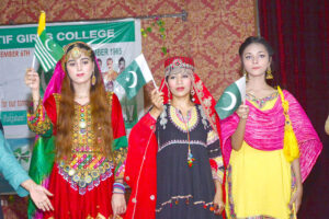 Students performing in tableau on stage during function on the occasion of Pakistan Defense Day at Shah Latif Girls College, Latifabad