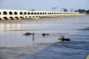 A view of boat parked in front of Lansdowne Bridge and Ayub Bridge at Left Bank of Indus River near Rohri