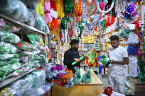 A shopkeeper is arranging decorations items for selling in connection with Eid Milad-un-Nabi (PBUH) as Muslims celebrate Eid Milad un Nabi,on the birthday of the Islamic prophet Hazrat Muhammad (PBUH) on the 12th day of Rabi’ al-awwal at in the city.