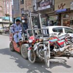 A traffic lifter towing away motorcycles parked incorrectly at Gole Chowk