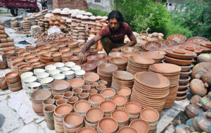 A vendor display and sells pottery at his roadside setup.