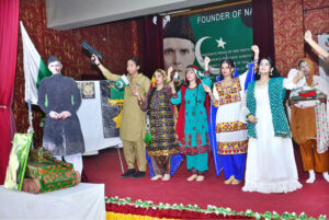 Students performing in tableau on stage during function on the occasion of Pakistan Defense Day at Shah Latif Girls College, Latifabad