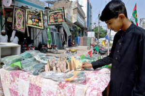 A vendor displays decorative items in connection of Eid Milad-un-Nabi (PBUH) as Muslims celebrate Eid Milad un Nabi, the birthday celebration of prophet Hazrat Muhammad (PBUH) on the 12th day of Rabi’ al-awwal in the city