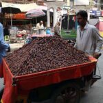 Vendor selling and displaying dates to attract the customers in front of Dhaki Dalgaran