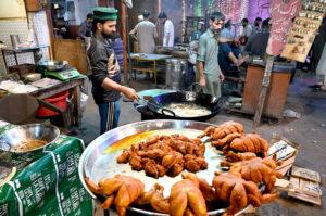 A vendor roasting chicken at his roadside setup.