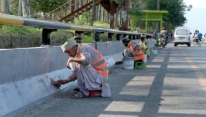 CDA workers are busy painting and repairing roadside edges at Zero Point to enhance the beautification of the federal capital.