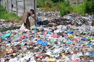 A gypsy boy searching valuables from garbage near Khanna Pul area in the Federal Capital
