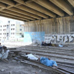 Labourers taking nap to rest under the flyover near railway station