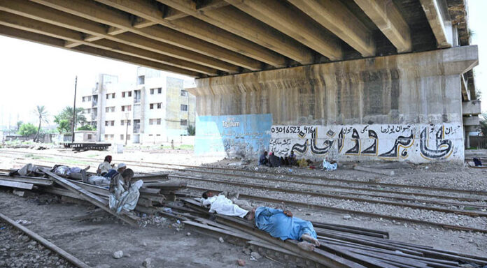 Labourers taking nap to rest under the flyover near railway station
