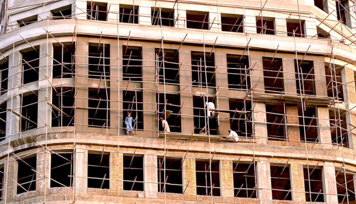 Laborers busy in building construction work near F9 Park in the Federal Capital