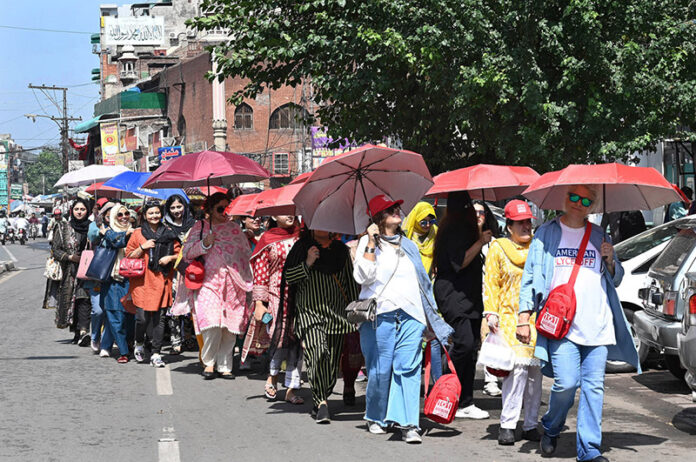 A large group of female tourists explores the beauty of the walled city during a guided tour organized by 101 Historical Education Tours of Pakistan at Anarkali Bazaar