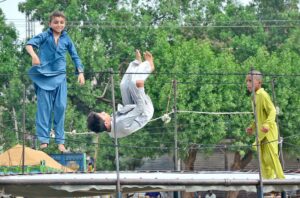 Youngsters are enjoying while jumping on trampoline at Latifabad.