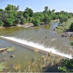 A view of youngsters bathing and swimming in the Rawal Dam spillway water