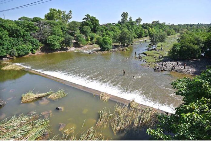 A view of youngsters bathing and swimming in the Rawal Dam spillway water