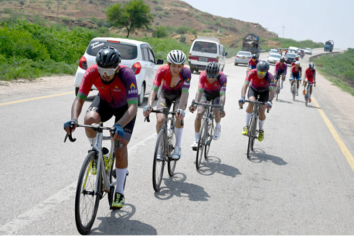 Cyclists participating in a Cycle Race from Karachi to Jhampir on National Highway on the eve of Defense and Air Force Day organized by SSGC near Jhirk