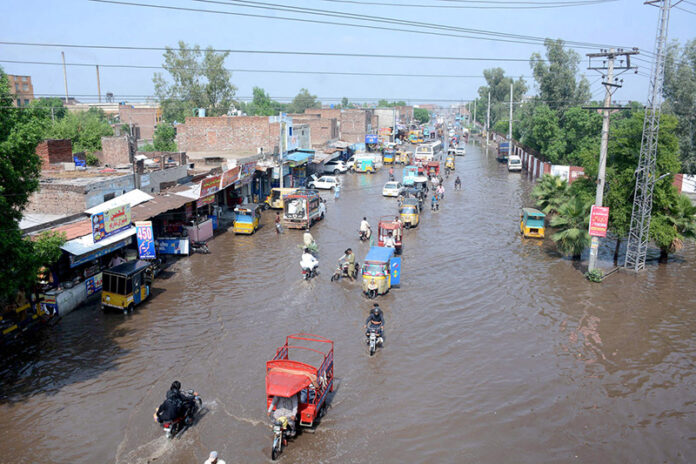 Vehicle passing through stagnant rain water accumulated at Nishatabad after heavy rain in the city