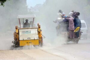 A CBH worker uses machinery to clear dust from the road at Thandi Sarak, busy restoring cleanliness and visibility in the city .