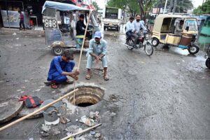 Municipal workers are busy cleaning the main hole near Railway Station