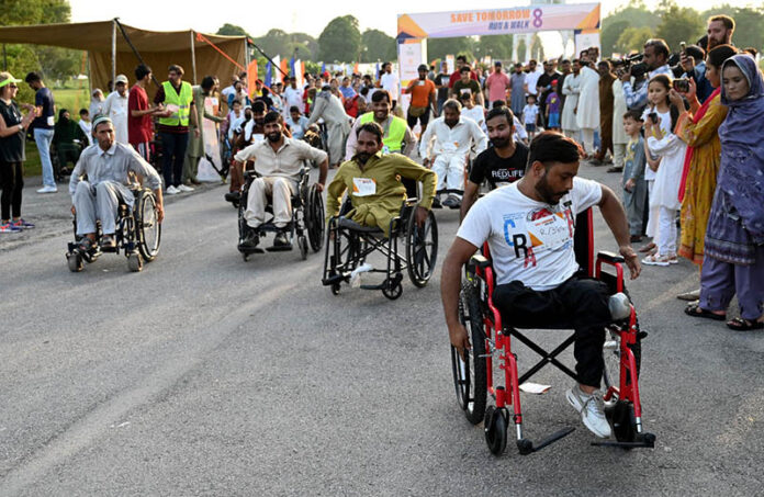 Disabled individuals participate in the 8th edition of the 'Save Tomorrow' Run & Walk, highlighting the issue of drug abuse in society, hosted by the Karim Khan Afridi Welfare Foundation (KKAWF) at Fatima Jinnah Park (F-9) in the Federal Capital