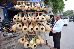 A street vendor sells handmade bird nests for gardens