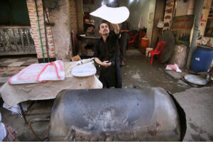Bread maker prepares traditional roti, locally called "chapati," for customers at Fawara Chowk.