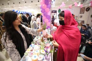 A woman displaying her creations on her stall during the Education Expo 24.