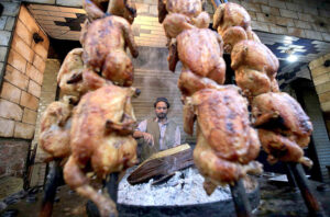 Vendor preparing and selling traditional food item sajji to attract the customers at Fawara Chowk.