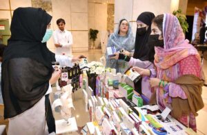 Female visitors show interest in a pharmaceutical stall during World Pharmacists Day, organized by the Young Pharmacists Community Pakistan.