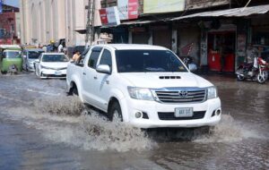 Vehicles passing through stagnant rain water accumulated at Jail Road.
