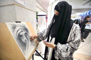 A woman displaying her creations on her stall during the Education Expo 24.