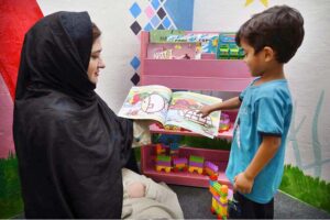 A child reading a book in a counselling room during Inauguration ceremony of Child Protection Unit District Khyber.