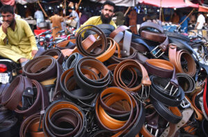 A vendor displaying and selling the leather belts on his handcart at Landa Bazar in the Provincial Capital