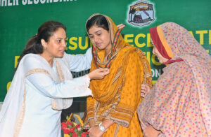Commissioner Maryam Khan is awarding medals to position holder students during the result declaration ceremony of the intermediate examination at the Board of Intermediate and Secondary Education.