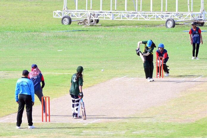 Women cricket Players in action during women’s cricket match between mayor green women cricket team and mayor blue women cricket team on Pakistan defense day at Niaz Stadium