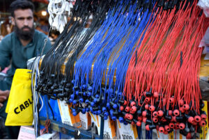 A vendor displaying and selling the leather belts on his handcart at Landa Bazar in the Provincial Capital