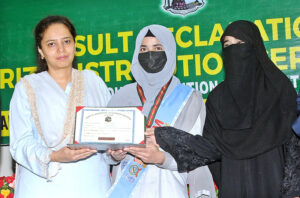 Commissioner Maryam Khan is awarding medals to position holder students during the result declaration ceremony of the intermediate examination at the Board of Intermediate and Secondary Education.