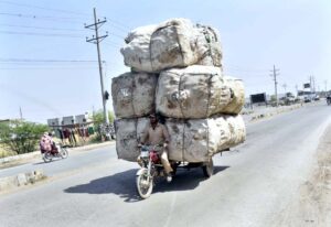 An overloaded motorcycle rickshaw makes its way onto the Natho road, creating potential safety hazards for other vehicles