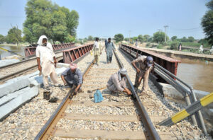 Railway workers are busy in repairing railway tracks near New Multan Railway Station during repairing and maintenance work, ensuring safety and preventing accidents.