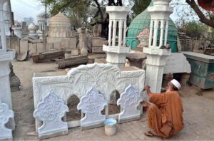 An artisan meticulously applies the final touches to mosque slabs and minarets at his workshop, crafting pieces of beauty and devotion.
