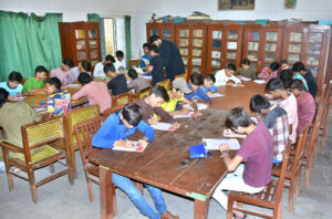 Students solving the question papers during pre-entry test for admission in Government Comprehensive Higher Secondary School at Latifabad.
