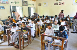 Students solving the question papers during pre-entry test for admission in Government Comprehensive Higher Secondary School at Latifabad.