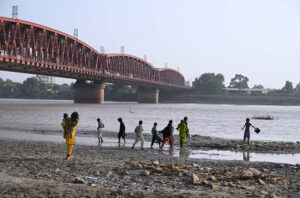 Gypsy children bathe in the Indus River during their travel at Husenabad.