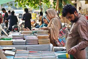 People selecting and purchasing second hand toys from roadside vendor in Provincial Capital